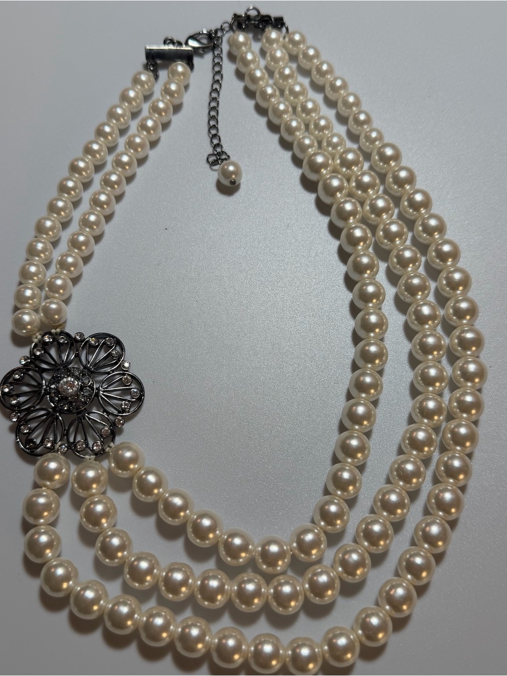 Triple-Strand Ivory Pearl Necklace with Filigree Accent